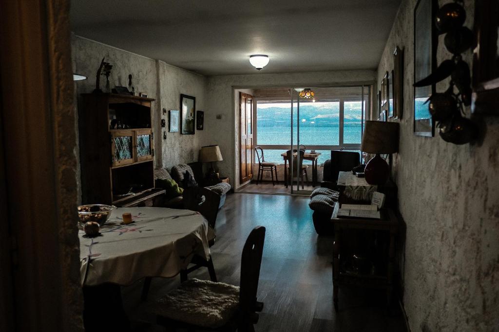 a living room with a table and a view of the ocean at La Generosa in San Carlos de Bariloche