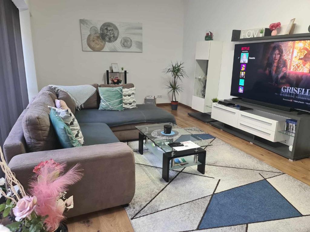 a living room with a couch and a flat screen tv at Wohnung 51 in Oberwesel