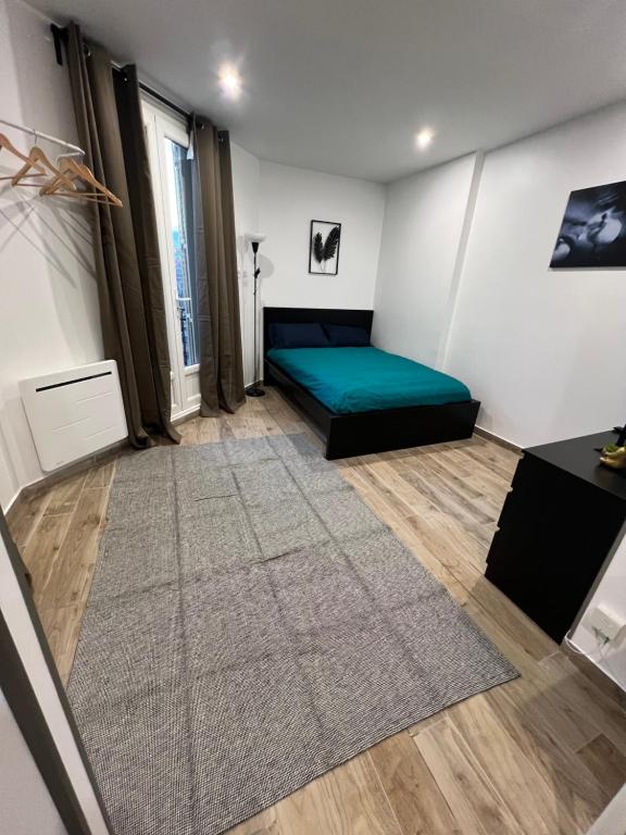 En eller flere senge i et værelse på Studio spacieux refait à neuf (4)