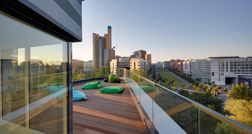 a balcony with a view of a city at Grimm's Potsdamer Platz in Berlin