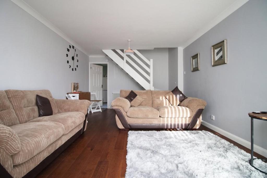 a living room with two couches and a staircase at Cohost Partners: Perfect Retreat in Bristol in Bristol