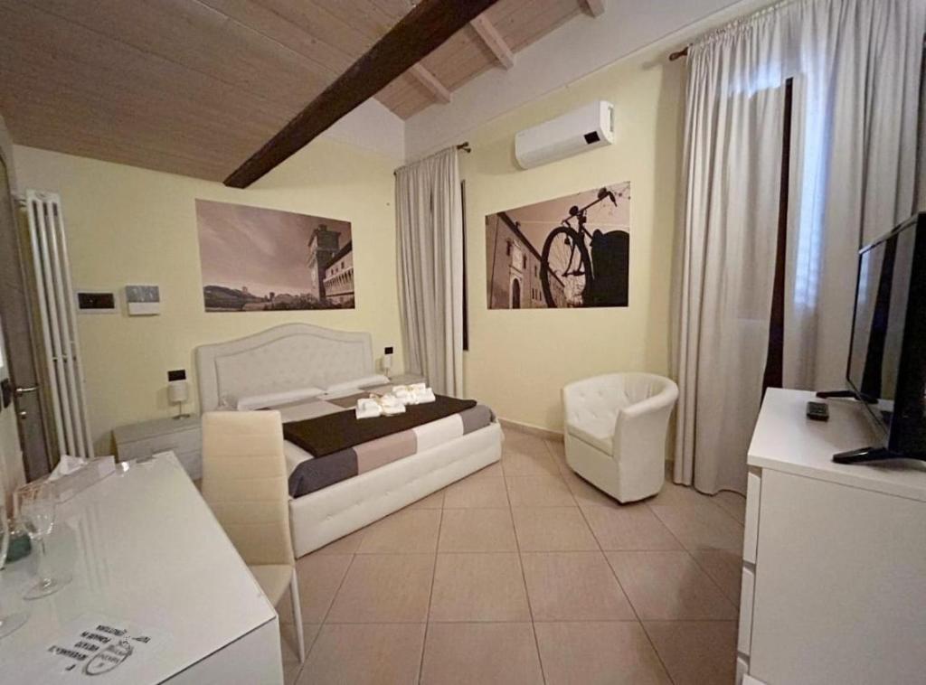 a bedroom with a bed and a tv in a room at DIMORA AL SARACENO in Ferrara
