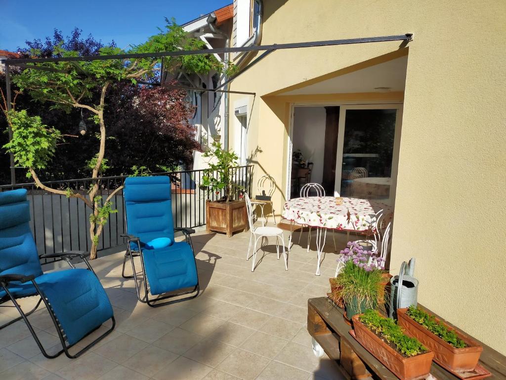 a patio with chairs and a table on a balcony at Le Jardin du Dolaizon in Le Puy-en-Velay