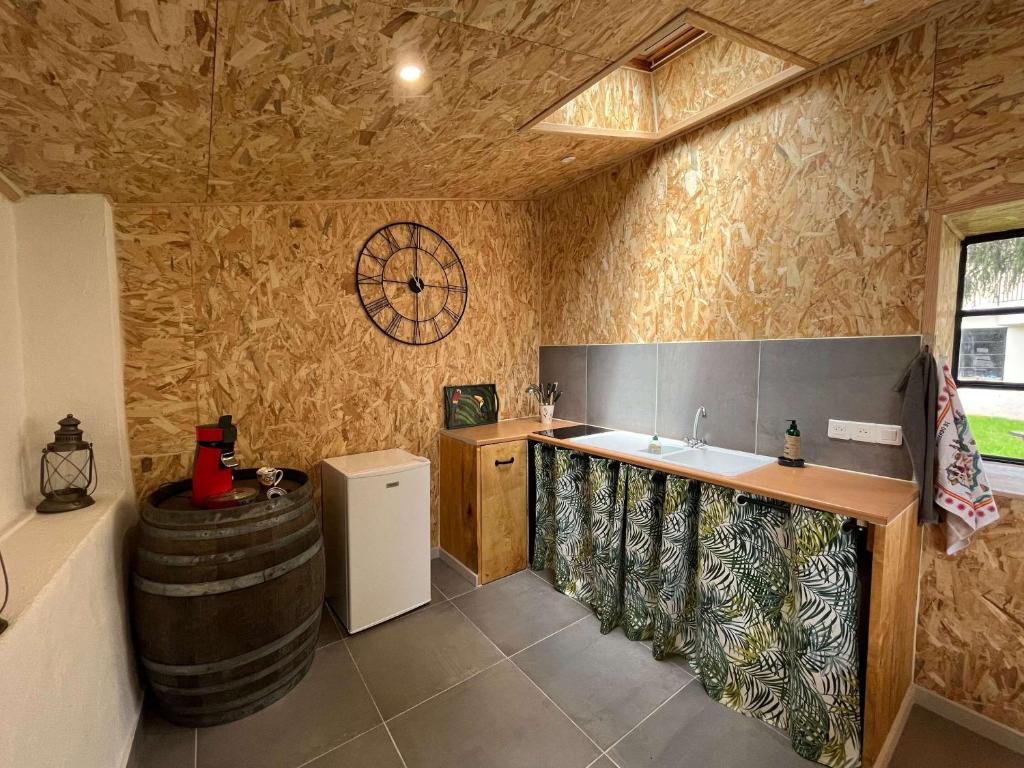 a kitchen with a sink and a barrel at Le Jardin du Dolaizon in Le Puy-en-Velay