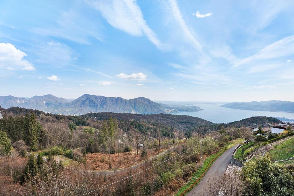 a road in the mountains with a view of a lake at Appartamento Bella Vista in Premeno