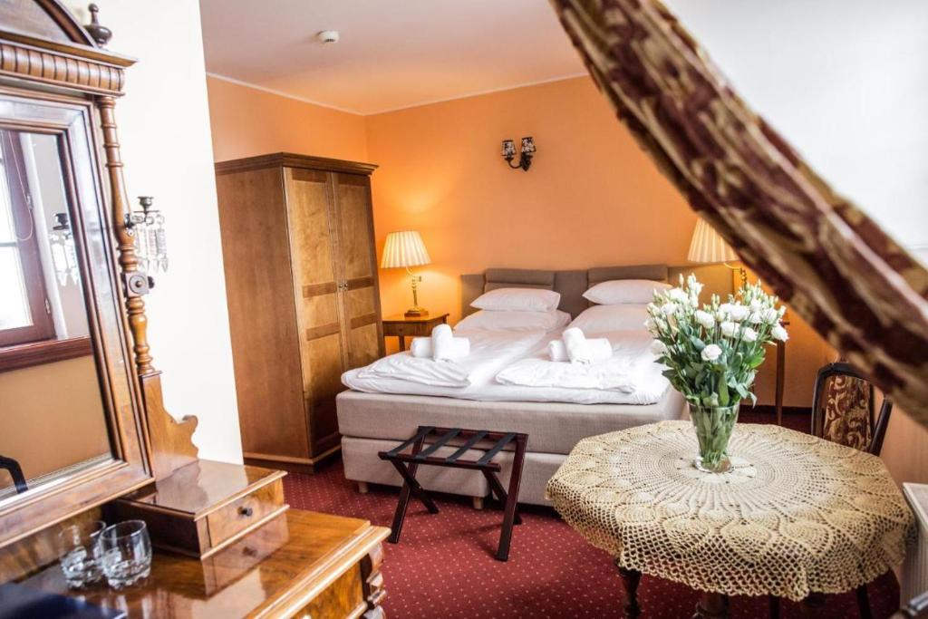 Postel nebo postele na pokoji v ubytování Pałac na Wodzie Hotel & SPA