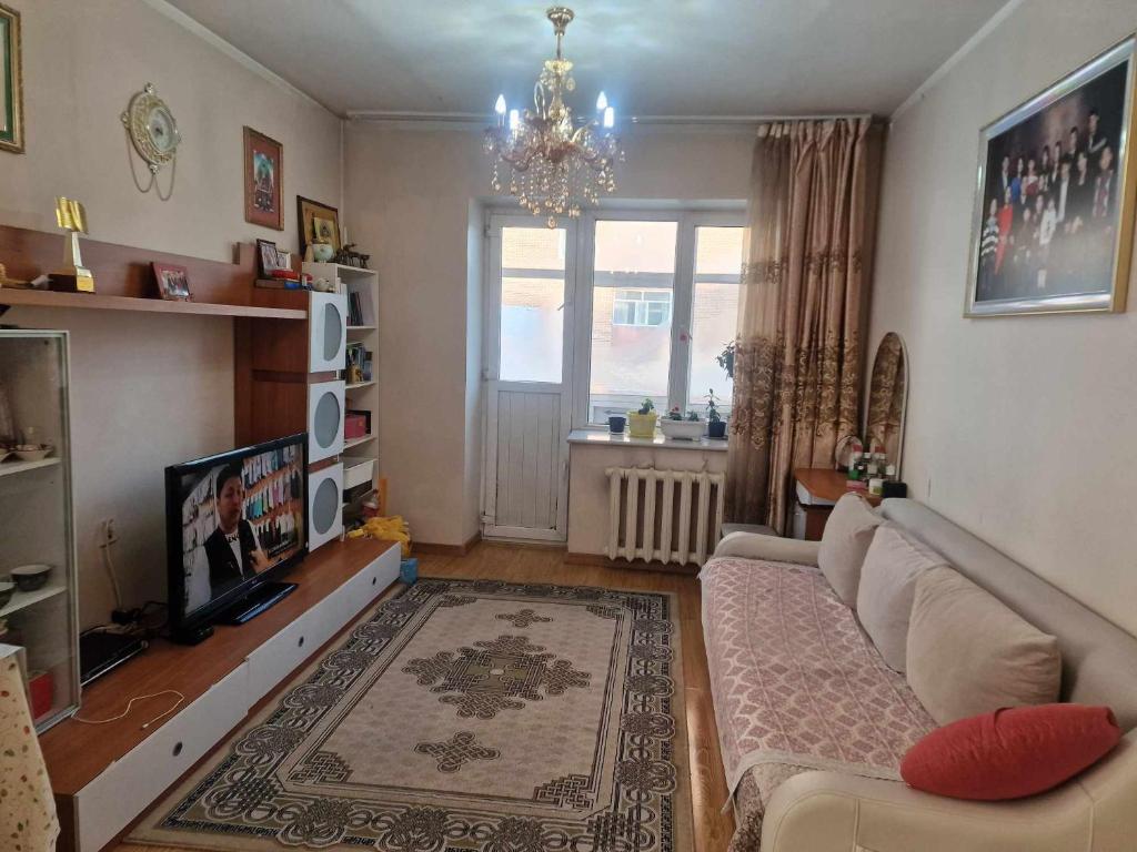 uma sala de estar com um sofá e uma televisão em One bedroom apartment em Ulan Bator