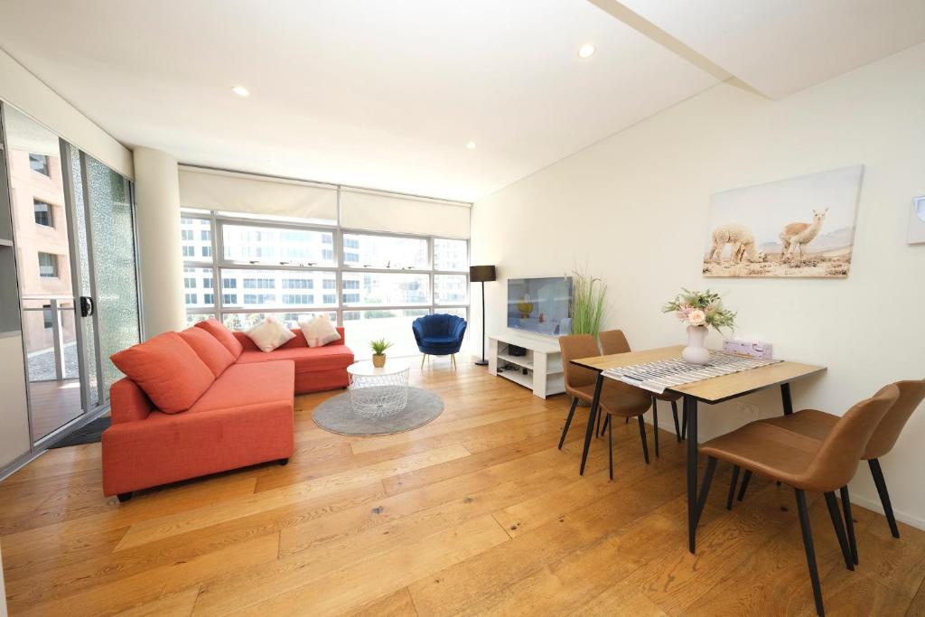 a living room with a couch and a table at Alora Apartment in Sydney CBD - Darling Harbour in Sydney
