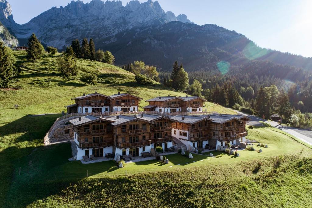 an aerial view of a large house in the mountains at Wochenbrunner Chalets in Ellmau
