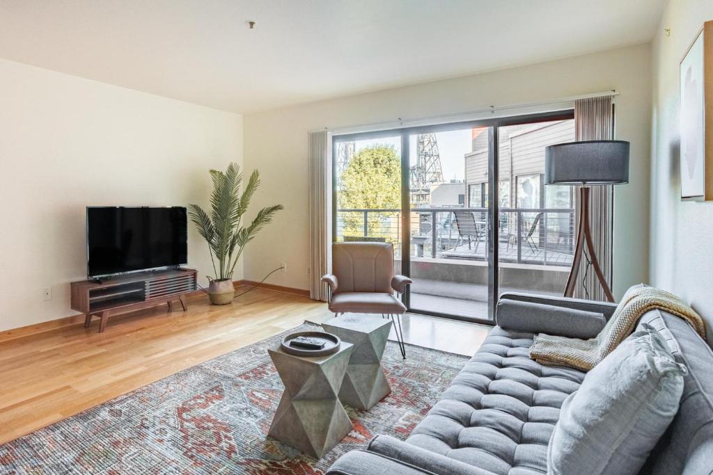 a living room with a couch and a tv at Old Town 1br near dining bars tech hubs PDX-15 in Portland