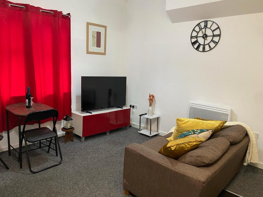 a living room with a couch and a flat screen tv at Branxiar Suite - 1bedroom Executive Suite & Apartment in Wallsend in Old Walker