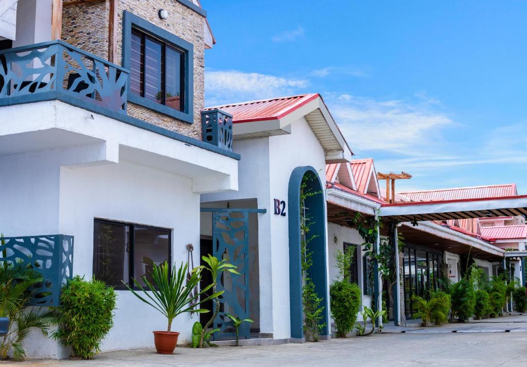 a white building with a surfboard on a street at Homegate Resort in Lekki