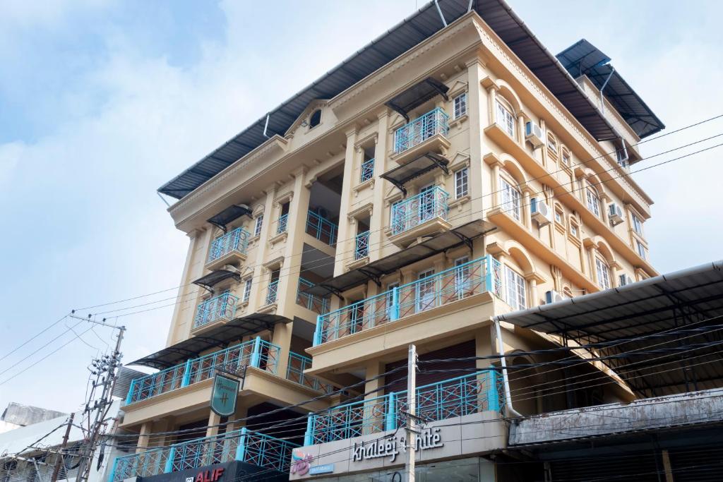 a building with blue balconies on the side of it at Hamsted in Kottakkal