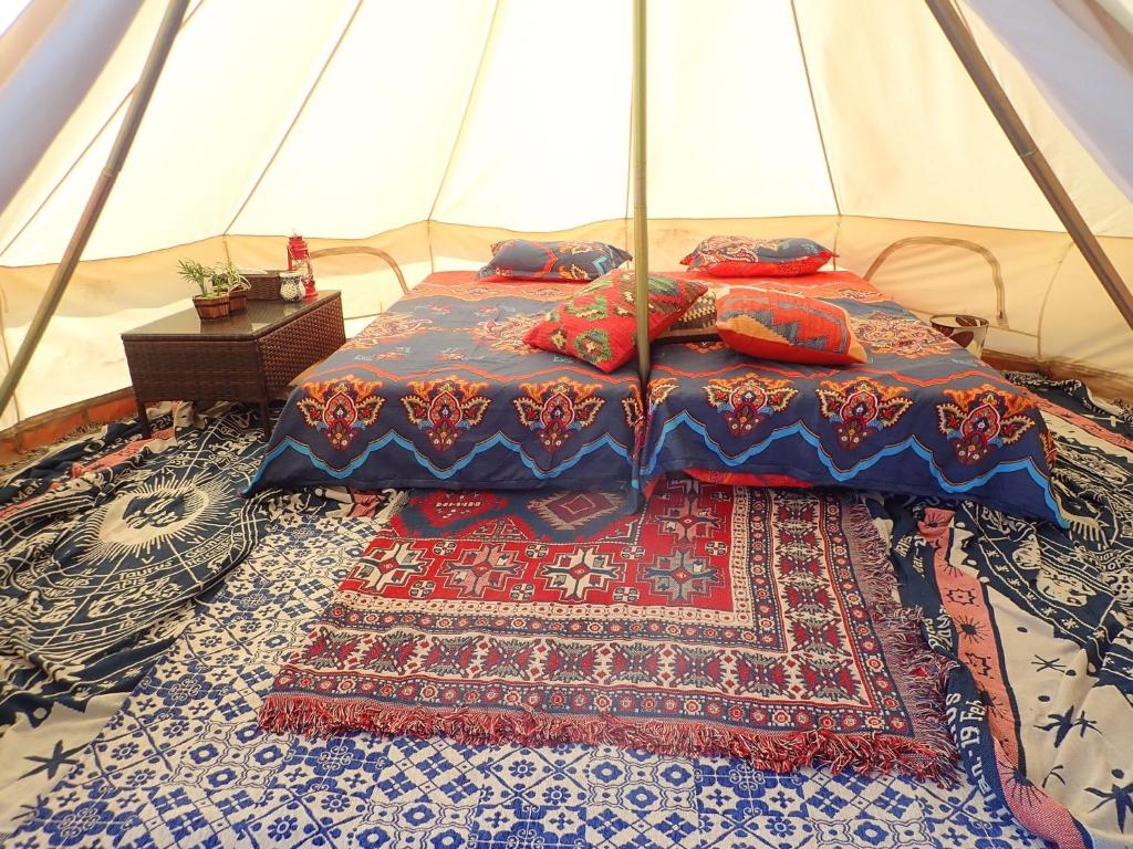 two beds in a tent with a rug at Grand Beach - Vacation STAY 23978v in Iki