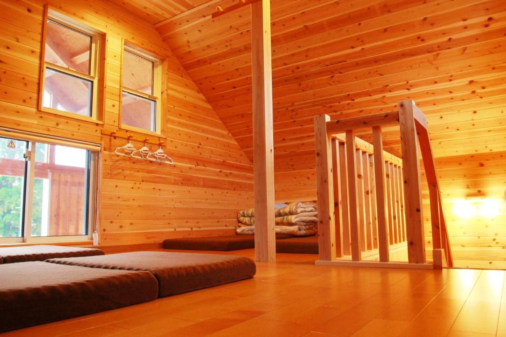 a log cabin with a bed in a room at Hirugano Kogen Cottage Park Shikinosato - Vacation STAY 23984v in Shōgahora