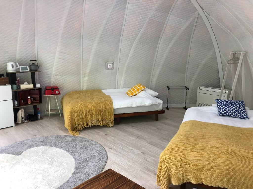 a room with two beds in a tent at ASOGUNI Glamping - Vacation STAY 42112v in Oguni