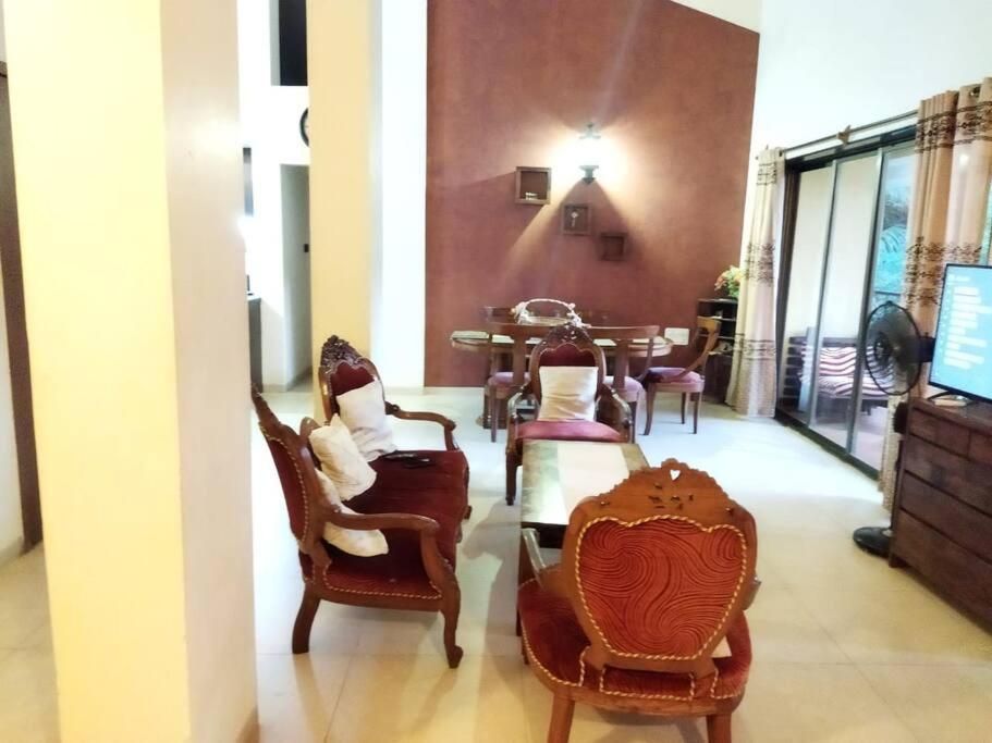 a room with chairs and a table and a dining room at 3BHK Luxury House near Calangute/Bagha(C4) in Anjuna