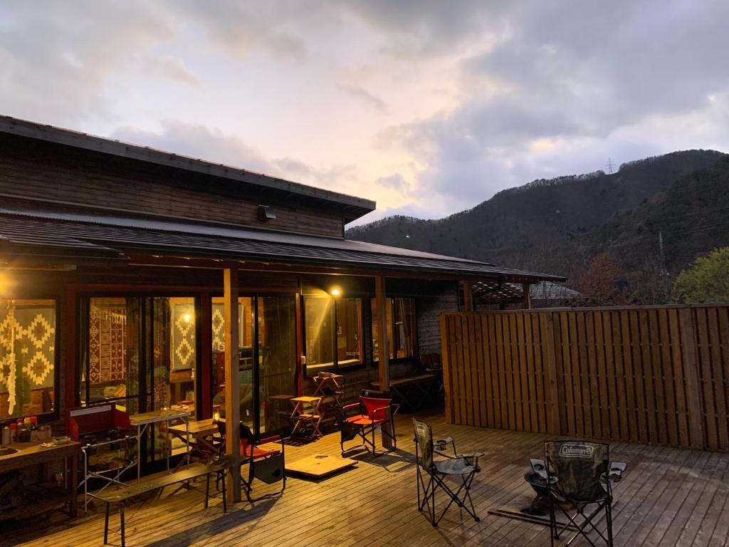 a house with chairs and tables on a deck at AKAYA GLAMPING HOUSE - Vacation STAY 41979v in Fukuro