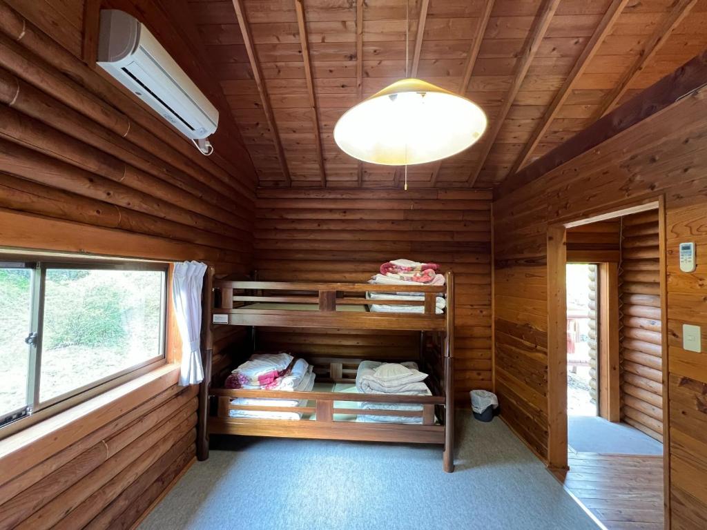 Nasu Takahara Auto Campsite - Vacation STAY 42064v في ناسوشيوبارا: غرفة مع أسرة بطابقين في كابينة خشب
