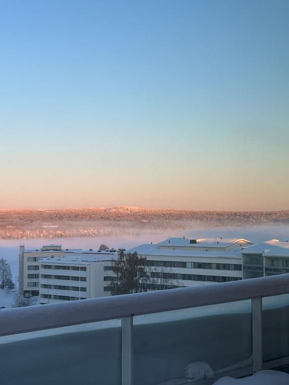 arial view of a building with a lake in the background at Penthouse in the city center in Rovaniemi