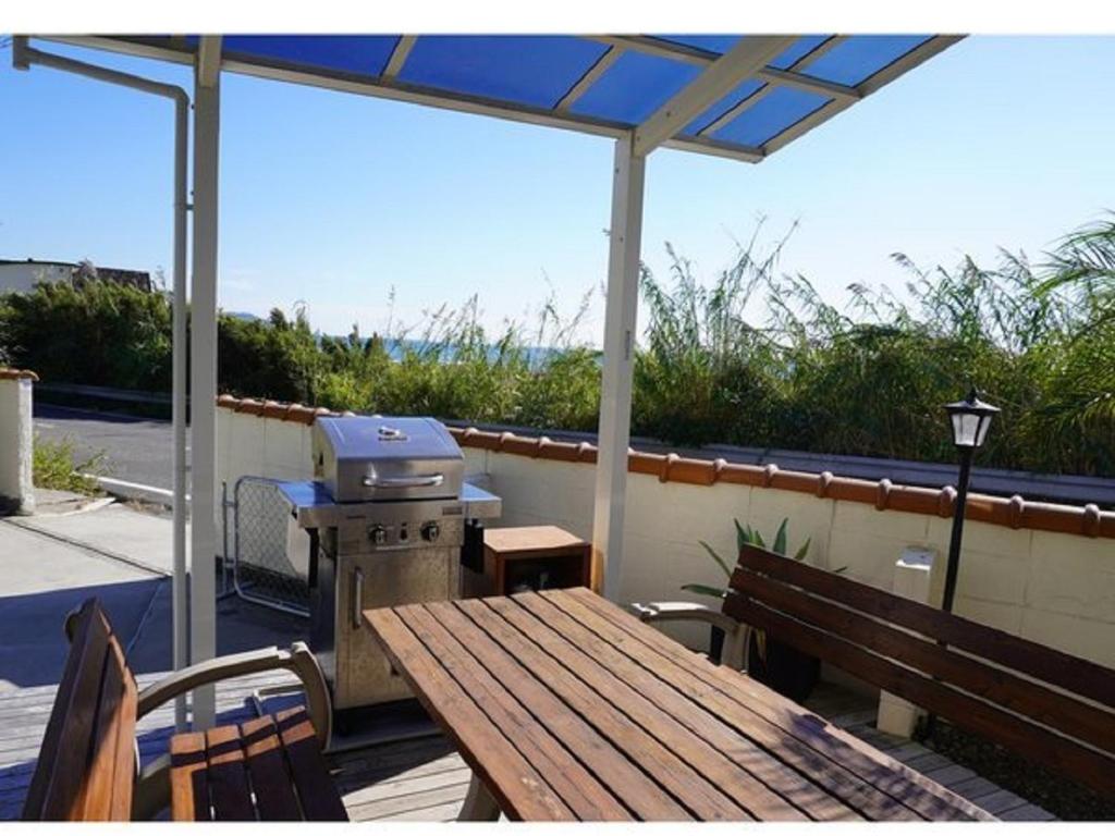 a picnic table with a grill and a bench at Villa & BBQ grounds Palm Village - Vacation STAY 42254v in Otohama