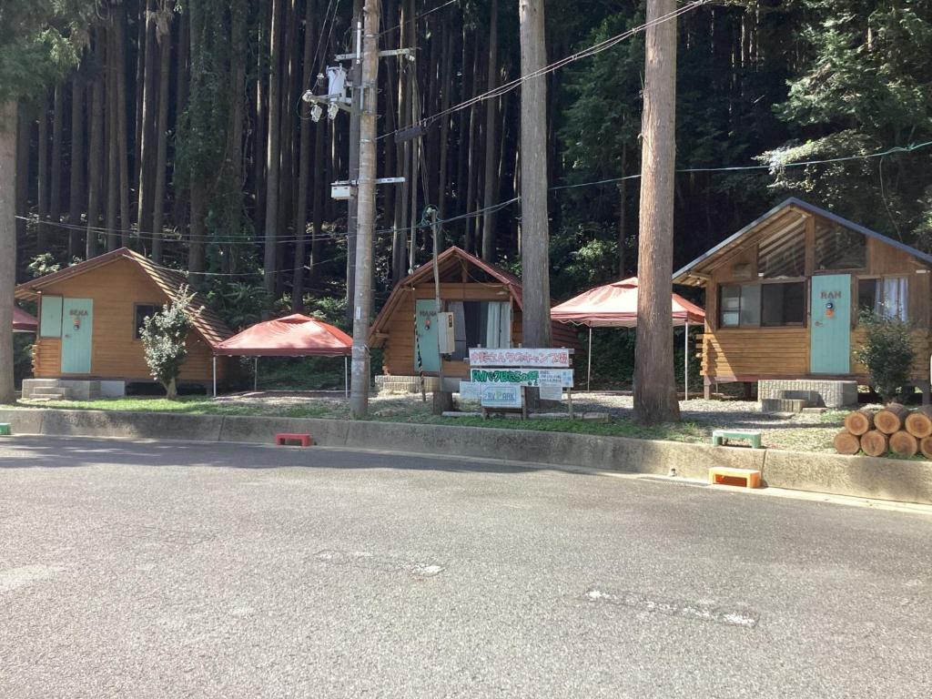 a couple of small wooden houses on the side of a road at Nakano-san Chi Campsite & RV Park Hotaru no Sato- Camp - Vacation STAY 42210v in Higashi-shibuta