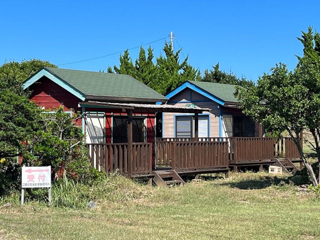 a house with a wooden fence in front of it at Hasaki Seaside Campsite - Vacation STAY 51117v in Shari