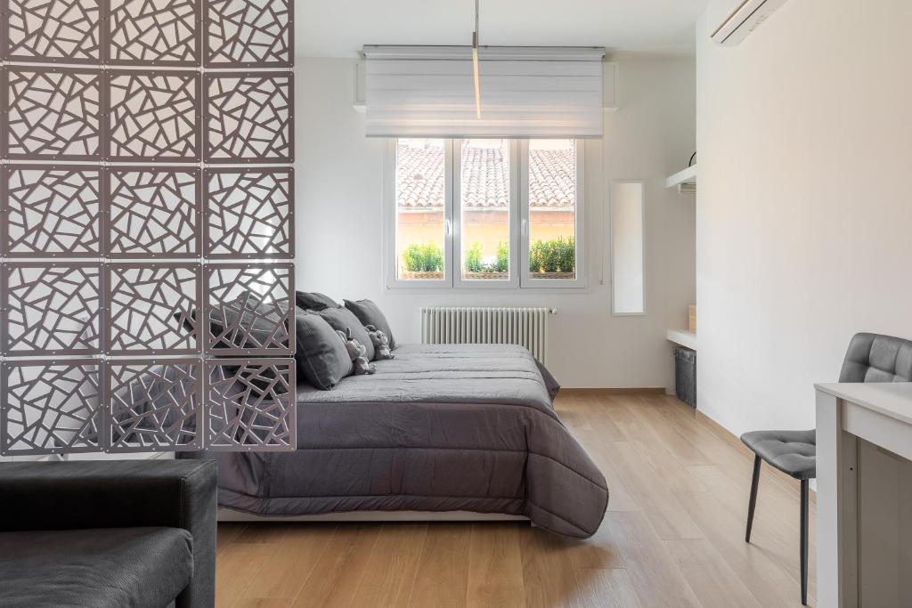 a bedroom with a bed and a window at La dimora degli asinelli in Bologna