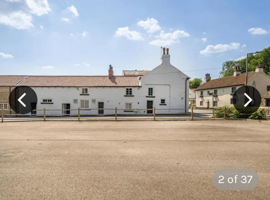 a large white building with two arrows on it at Immaculate 6-Bed Ivy house in Doncaster