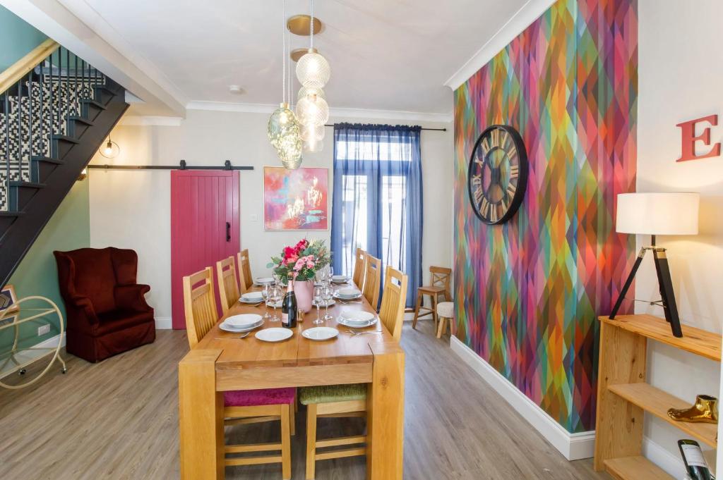 a dining room with a table and a colorful wall at The Milton sleeps 8 close to York city centre pet friendly in York