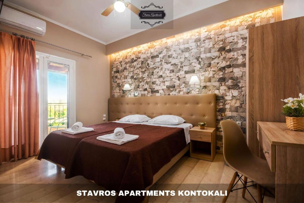 a hotel room with a bed with towels on it at Stavros Apartments Kontokali next to Gouvia Marina in Kontokali