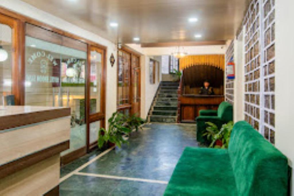 a lobby of a store with a green couch at Hotel Muscatel BhumSang Darjeeling in Darjeeling