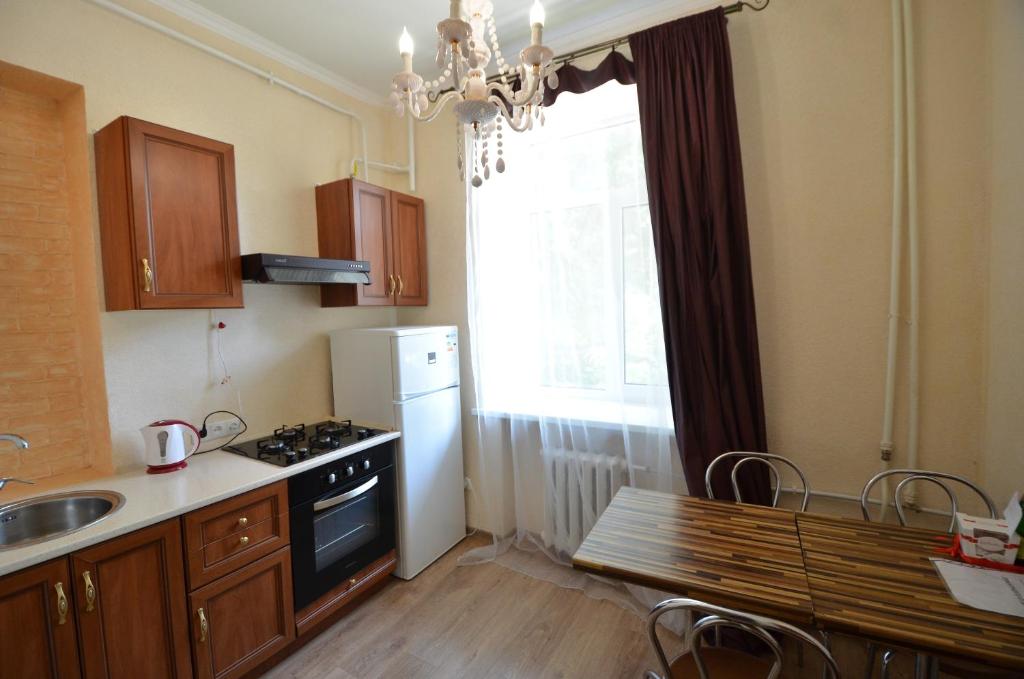 a kitchen with a stove and a sink and a window at Apartments on Sobornaya Street near the waterfront in Mykolaiv