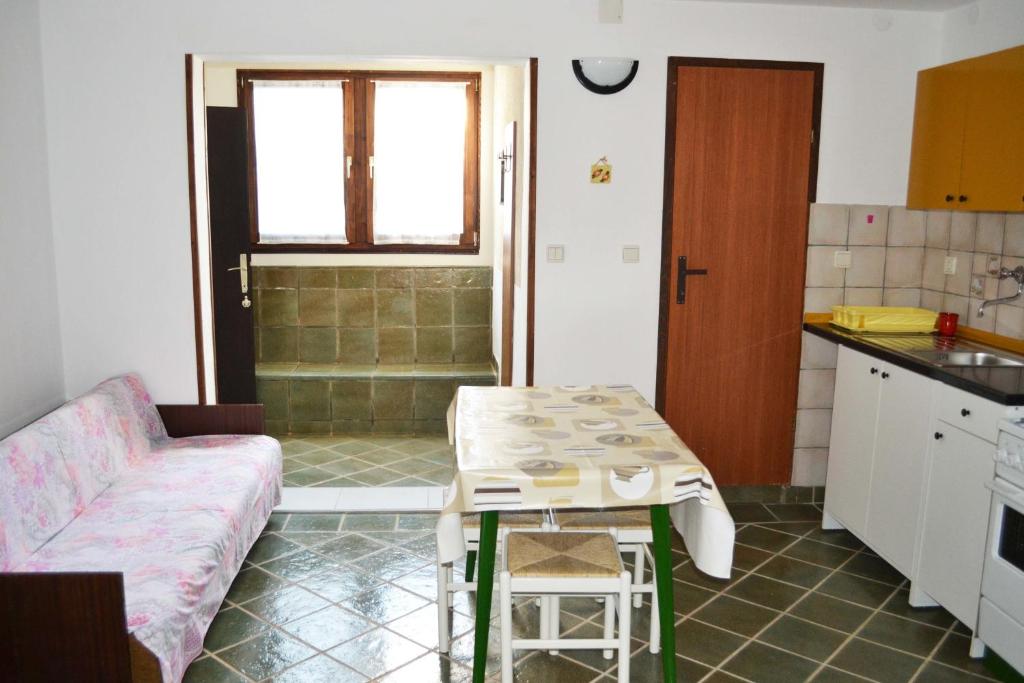 a kitchen with a couch and a table in a room at Studio Apartment ''k'' in Pula