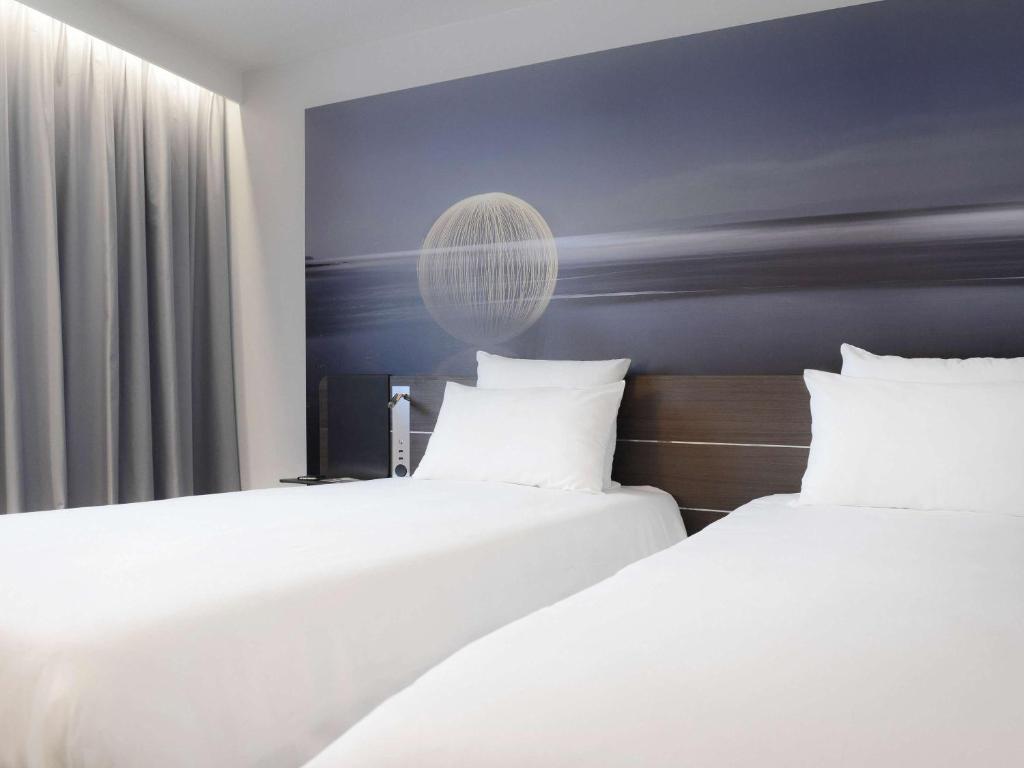 Postel nebo postele na pokoji v ubytování Novotel Valence Sud