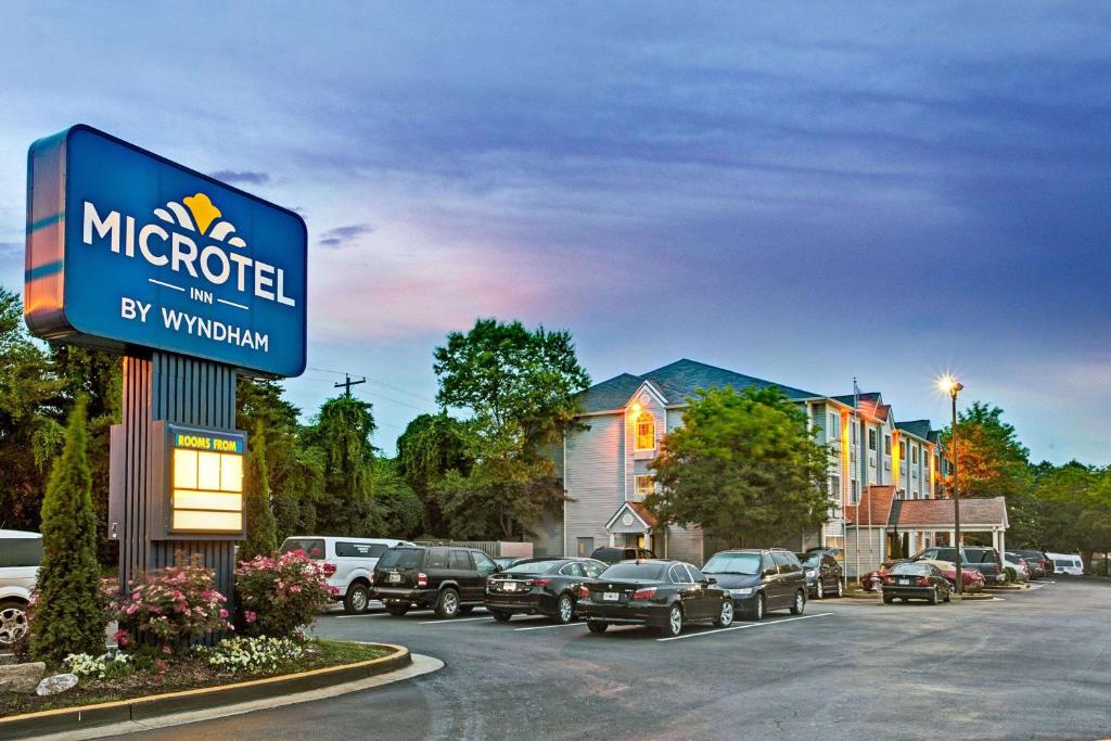 a sign for a mccord by winthrop with parked cars at Microtel Inn by Wyndham Atlanta Airport in Atlanta