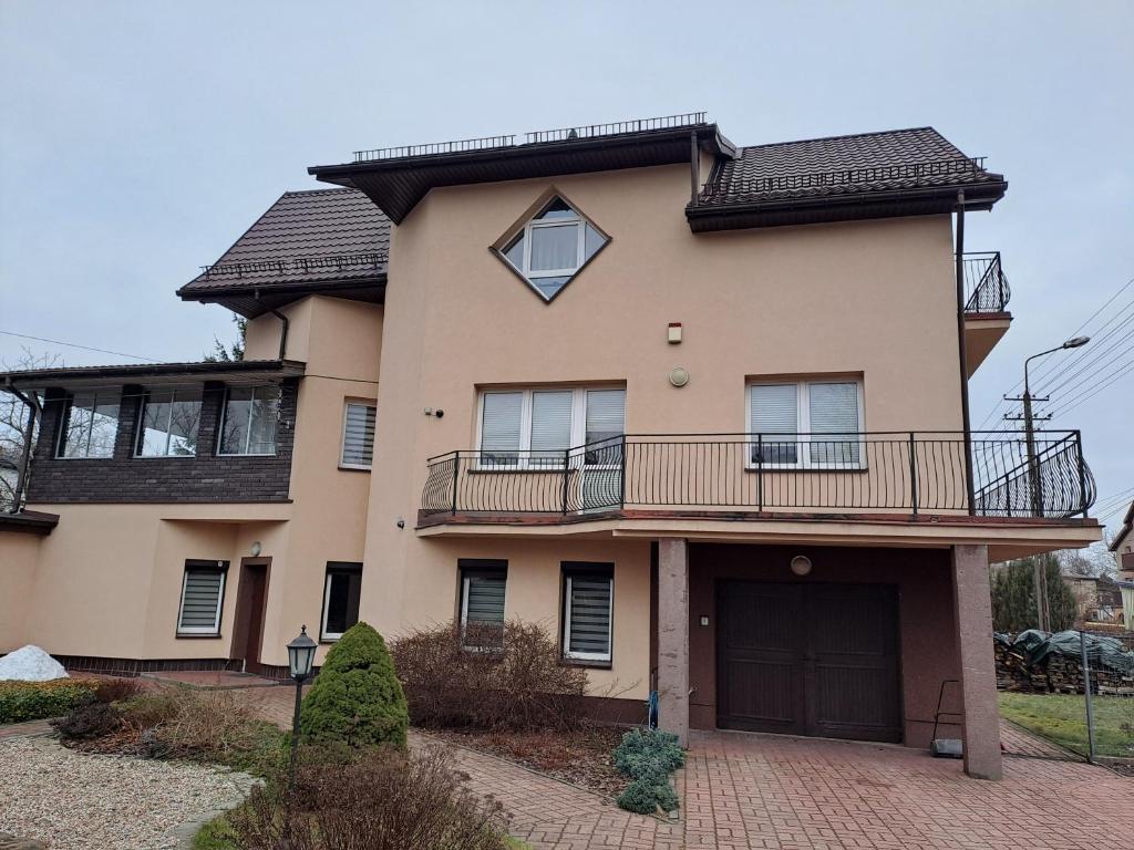 a large house with a balcony on top of it at Pokoje Zielonka in Zielonka