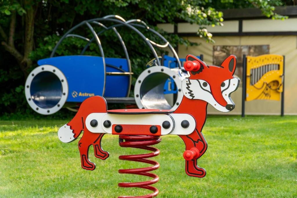 a red fox on a playground ride in a park at Stonka in Chłopy