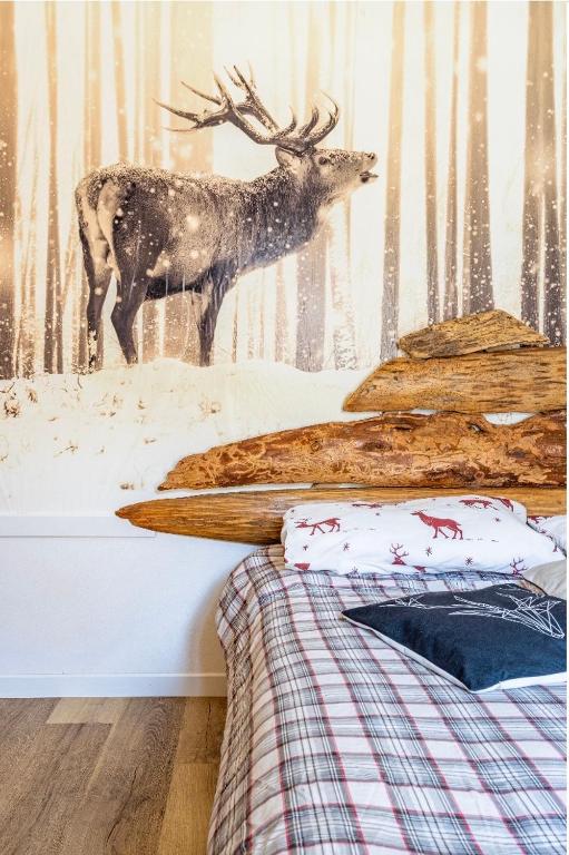 a mural of a deer in the snow in a bedroom at Il Baitino Innamorato in Pragelato