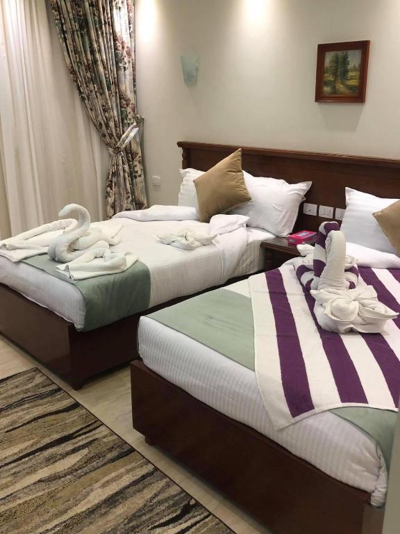 Postel nebo postele na pokoji v ubytování Amwaj Hotel