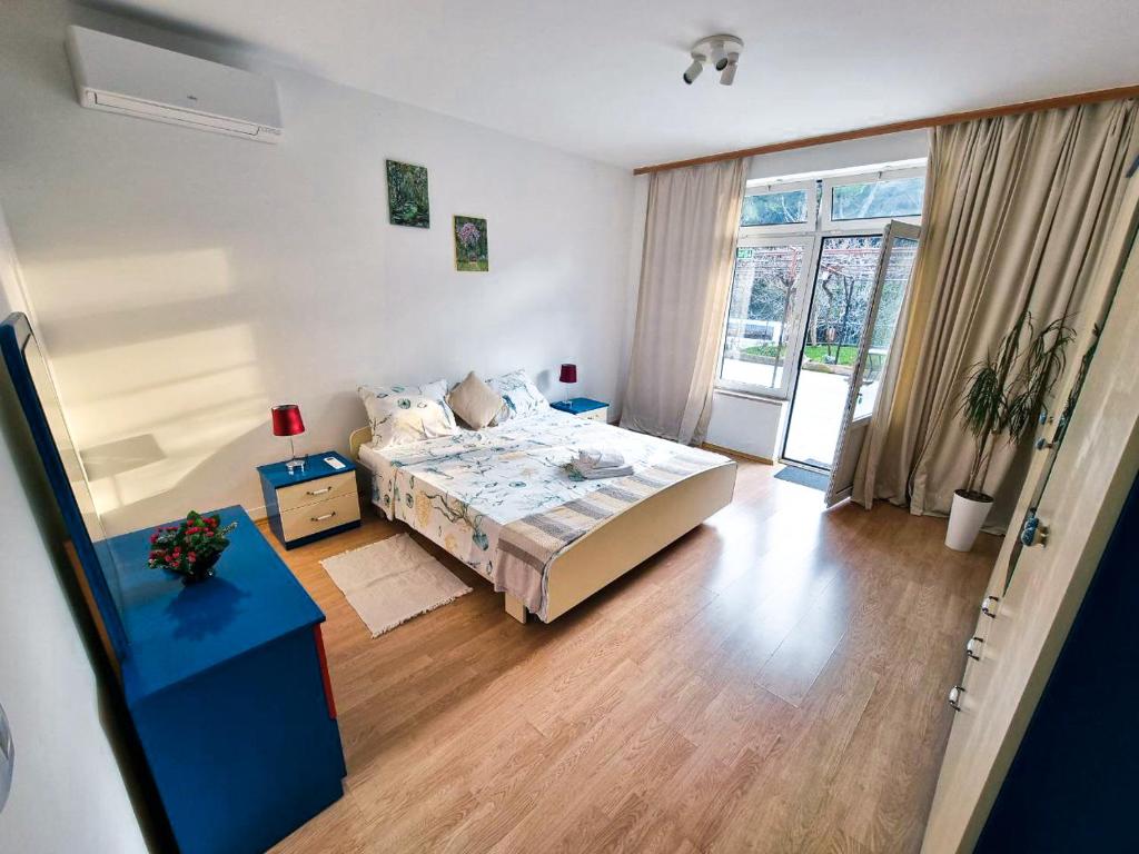 a bedroom with a bed and a table and a window at Retreat Apartments with free parking in Pula