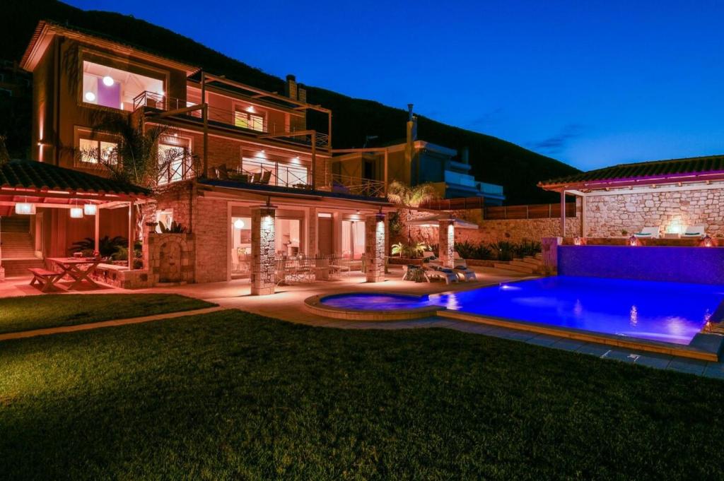 a house with a swimming pool in the yard at Infinite Blue Epidavros in Ancient Epidauros