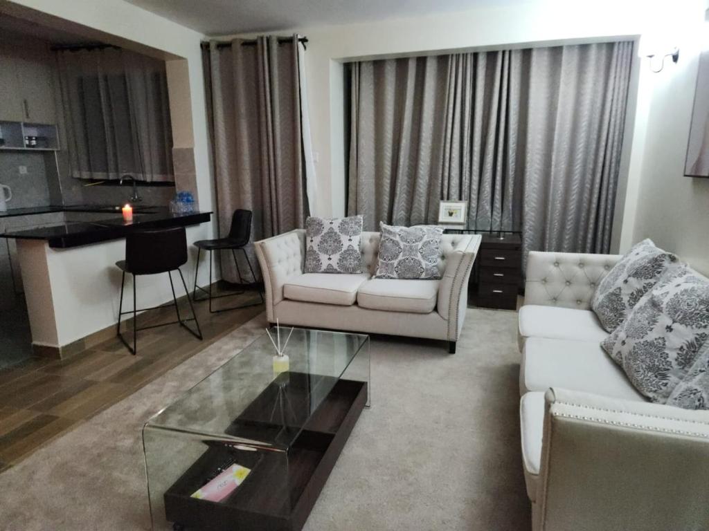 a living room with a couch and a table at 1 bedroom at Alessa Executive Apartments 1103 in Nairobi