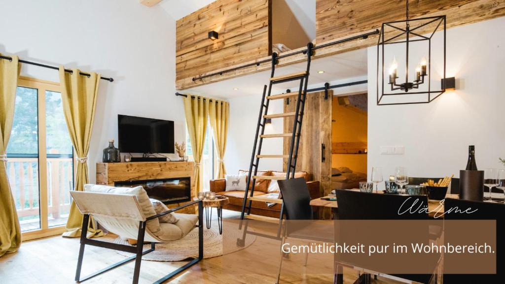 a room with a loft bed and a dining room at Zirben -Chalet 1 in Winkl Heiligenblut
