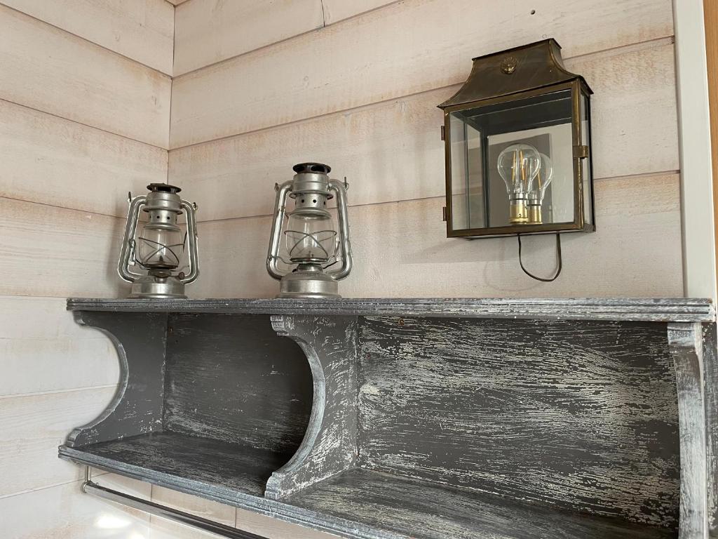 a shelf with two glass jars on top of it at La Maison Bizienne Guérande in Guérande