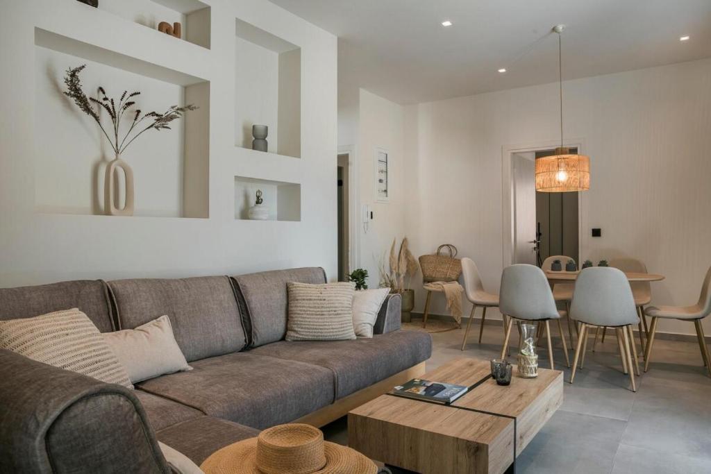 a living room with a couch and a table at Mystique Lagoon Villa in Argostoli