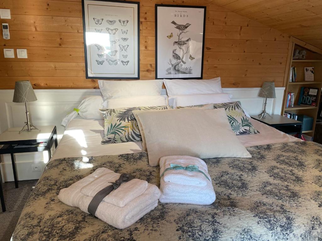 a large bed with towels on it in a room at La Maison Bizienne Guérande in Guérande