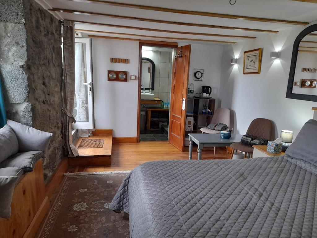 a bedroom with a bed and a living room at Lost in Thyme in Lajes do Pico