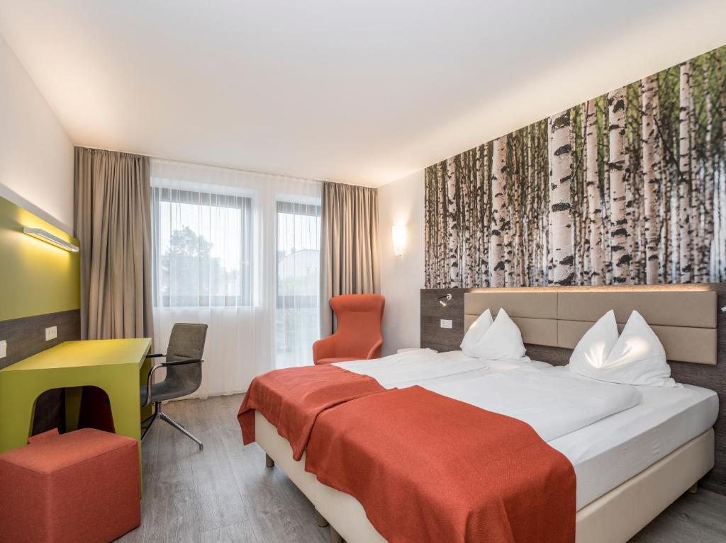 Postel nebo postele na pokoji v ubytování Eco Suite Hotel