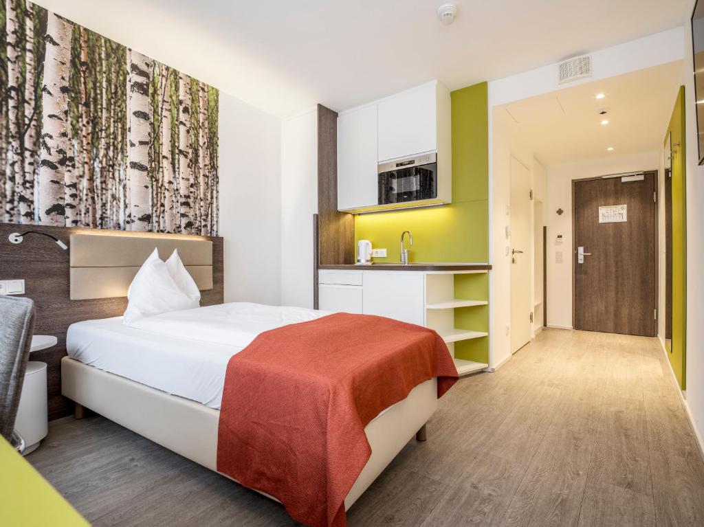 Postel nebo postele na pokoji v ubytování Eco Suite Hotel